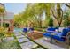 Outdoor oasis featuring a fire pit, lounge seating, and lush landscaping at 9500 Balatta Canyon Ct, Las Vegas, NV 89144