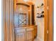 Wine bar area featuring custom wood cabinets, mosaic backsplash, and wine racks at 9500 Balatta Canyon Ct, Las Vegas, NV 89144