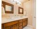 Bathroom features double sinks with framed mirrors and classic wood cabinetry at 9500 Balatta Canyon Ct, Las Vegas, NV 89144