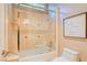 Tiled shower-tub combination with glass door, toilet and light fixture at 9500 Balatta Canyon Ct, Las Vegas, NV 89144