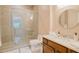 Bathroom featuring a walk-in shower and vanity with tiled backsplash at 9500 Balatta Canyon Ct, Las Vegas, NV 89144