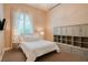 Bright bedroom with carpet, built-in storage, and a large window with sheer curtains at 9500 Balatta Canyon Ct, Las Vegas, NV 89144