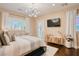Stylish bedroom featuring hardwood floors, modern lighting, and white decorative curtains at 9500 Balatta Canyon Ct, Las Vegas, NV 89144