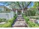Inviting walkway through manicured hedges lead to the front door of this residence at 9500 Balatta Canyon Ct, Las Vegas, NV 89144