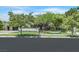 A well-maintained yard and mature trees frame this attractive home with a dark garage door at 9500 Balatta Canyon Ct, Las Vegas, NV 89144