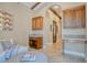 Hallway featuring built-in cabinets, arched doorway, and neutral decor at 9500 Balatta Canyon Ct, Las Vegas, NV 89144