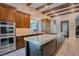 Well-equipped kitchen with a large center island, stainless steel appliances, and wood beams at 9500 Balatta Canyon Ct, Las Vegas, NV 89144