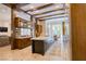 Spacious eat-in kitchen with dark wood beams, island, and stainless steel refrigerator at 9500 Balatta Canyon Ct, Las Vegas, NV 89144