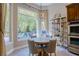 Light-filled breakfast nook with view of the exterior grounds, adjacent to the kitchen at 9500 Balatta Canyon Ct, Las Vegas, NV 89144