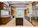 Gourmet kitchen with custom cabinets, center island, and stainless steel refrigerator at 9500 Balatta Canyon Ct, Las Vegas, NV 89144