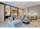 Open-concept living room featuring a chandelier, stylish decor, and an open layout to the kitchen at 9500 Balatta Canyon Ct, Las Vegas, NV 89144