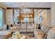 Spacious living room featuring stylish decor, wood beam ceiling, and an open layout to the kitchen at 9500 Balatta Canyon Ct, Las Vegas, NV 89144