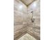 Tiled shower with stone floor and shower head in a modern home at 9500 Balatta Canyon Ct, Las Vegas, NV 89144