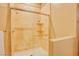 Shower featuring glass door, marble tiling, and shampoo shelves at 9500 Balatta Canyon Ct, Las Vegas, NV 89144