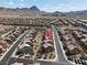 A captivating aerial view of a residential community nestled against a backdrop of majestic mountains at 1094 Paradise Resort Dr, Henderson, NV 89002