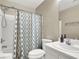Standard bathroom with shower-tub combo, neutral tile surround, and a white vanity and fixtures at 1094 Paradise Resort Dr, Henderson, NV 89002