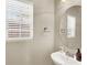 Bathroom with modern fixtures, including a sink, mirror, toilet, and window with blinds at 1094 Paradise Resort Dr, Henderson, NV 89002