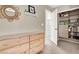 Bedroom closet has functional built-ins and organization, alongside a natural wood dresser and decorative shelf at 1094 Paradise Resort Dr, Henderson, NV 89002