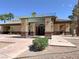 Inviting clubhouse entrance with shaded pergola, stone pillars, and professionally landscaped surroundings at 1094 Paradise Resort Dr, Henderson, NV 89002