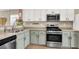 Modern kitchen offering stainless steel appliances, light green cabinets, and ample counter space at 1094 Paradise Resort Dr, Henderson, NV 89002