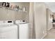 Functional laundry room with washer, dryer, and shelving for storage, offering convenience at 1094 Paradise Resort Dr, Henderson, NV 89002