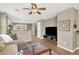 Open-concept living room with a ceiling fan, wood floors, and easy access to the stairs at 1094 Paradise Resort Dr, Henderson, NV 89002