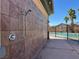 Convenient outdoor shower area located next to the pool with tile wall and multiple shower heads at 1094 Paradise Resort Dr, Henderson, NV 89002
