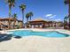 Resort-style pool with ample deck space, mature landscaping, and views of the clubhouse on a sunny day at 1094 Paradise Resort Dr, Henderson, NV 89002