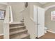 Staircase with carpet steps, white railing, and wall decor, leading to the upper level of the home at 1094 Paradise Resort Dr, Henderson, NV 89002