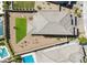 Aerial view of the backyard with a small turf area, desert landscaping, and a patio seating area at 12429 Alpenglow Ct, Las Vegas, NV 89138
