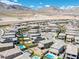 Stunning aerial view of a desert community with mountain views, well-maintained landscaping and several homes with private pools at 12429 Alpenglow Ct, Las Vegas, NV 89138