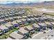 Aerial view of a vibrant community boasting modern homes, swimming pools, and desert mountain views at 12429 Alpenglow Ct, Las Vegas, NV 89138