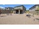 Expansive backyard area with gravel landscaping, a covered patio, fire pit, and mountain views at 12429 Alpenglow Ct, Las Vegas, NV 89138