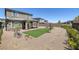 Expansive backyard boasts a patio area, low-maintenance desert landscaping, and a patch of green turf at 12429 Alpenglow Ct, Las Vegas, NV 89138