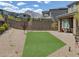 Well-maintained backyard features desert landscaping, small turf area, and a patio with seating at 12429 Alpenglow Ct, Las Vegas, NV 89138