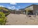 Spacious backyard with gravel and a patio area perfect for outdoor gatherings and enjoying the serene surroundings at 12429 Alpenglow Ct, Las Vegas, NV 89138