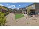 Spacious backyard featuring gravel landscaping, a small grassy patch, fire pit, and outdoor seating area at 12429 Alpenglow Ct, Las Vegas, NV 89138