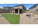 Expansive backyard boasts a patio area, low-maintenance desert landscaping, and a patch of green turf at 12429 Alpenglow Ct, Las Vegas, NV 89138