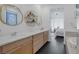 Bright bathroom featuring a double sink vanity with quartz countertops and modern fixtures at 12429 Alpenglow Ct, Las Vegas, NV 89138