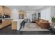 Spacious, open-concept living area with modern kitchen, stylish furnishings, and plenty of natural light at 12429 Alpenglow Ct, Las Vegas, NV 89138