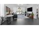Bright living area with sliding glass doors to outdoor patio, contemporary decor, and dark hexagon floors at 12429 Alpenglow Ct, Las Vegas, NV 89138