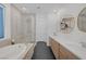 Modern main bathroom with a luxurious tub, walk-in shower, double vanity, and hexagon floors at 12429 Alpenglow Ct, Las Vegas, NV 89138