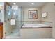 Bright bathroom boasts soaking tub with tile surround and glass enclosed shower at 125 E Harmon Ave # 2907, Las Vegas, NV 89109