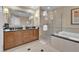 Bathroom features a double sink vanity with granite countertops, shower and separate soaking tub at 125 E Harmon Ave # 2907, Las Vegas, NV 89109