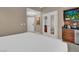 Comfortable bedroom featuring a white bed, light-colored walls, and double doors leading to another room at 125 E Harmon Ave # 2907, Las Vegas, NV 89109
