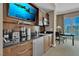 Condo kitchenette with stainless steel appliances, dark countertops, and a flat-screen TV at 125 E Harmon Ave # 2907, Las Vegas, NV 89109