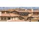 Rooftop view of community with terracotta roofing, desert landscaping and panoramic city views in the background at 160 Lomita Heights Dr, Las Vegas, NV 89138