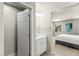 Bathroom with a white vanity and sink, and an adjacent bedroom with a view of the bed at 160 Lomita Heights Dr, Las Vegas, NV 89138