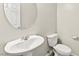 Clean half-bath with a pedestal sink, round mirror, white fixtures and tile flooring at 160 Lomita Heights Dr, Las Vegas, NV 89138