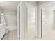 Bathroom with tiled floors, tub with shower, and view of the bedroom at 160 Lomita Heights Dr, Las Vegas, NV 89138